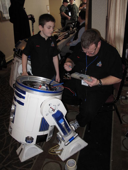 Alex and his dad Pat, working on their R2-D2.