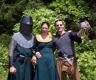 In the earlier part of the same day, I was in armor. I cheated in this one though.Look at the armor closely. The sleeves don't match the mantle, do they? The hauberkwas 16 gauge, thus reducing the weight significantly. Don't get me wrong, it was stillheavy. I was only wearing 32 pounds of chain instead of 48. :) From now on, if I weararmor to the renfests, I'll do what I did this day... Armor in the morning, then change into something else out in the parking lot sometime after lunch. :)