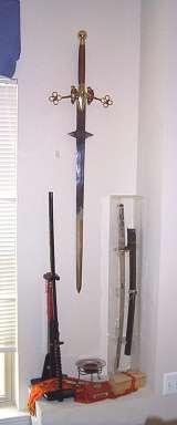 Here you can see my claymore, and two of my display katanas. The nicerof they two has its own (badly damaged) plexiglass case. (Click for larger view)
