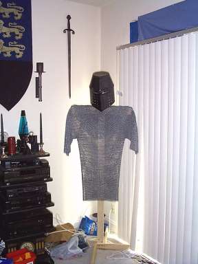 Here's my first set of armor... 48 lbs of chainmail plus a helmet, on a hardwood stand. Behind it is my first sword. (Click for larger view)