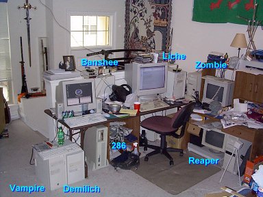 A new and relatively updated picture showing the network behind NecroBones.net.. Well,more or less. Ghoul isn't shown, and isn't currently hooked up, but thenagain it's only a 486 (but a really nice</I> 486).. And well, Demilichisn't my computer. And the 286 is just that- a 286. It lies dormantbetween my periods of nastalgic indulgence. The rest of the computers arein varying states of obselescence, and run a variety of OS's. Basically, the network represents the evolution of PC desktopcomputers, as it consists of the parts that I've accumulated over the years with each passing upgrade.