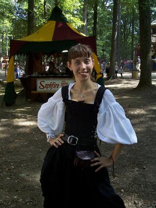 Here's the ever-lovely Lady Ketsia (Kat), at the MD Renaissance Festival.The picture was taken in the vacinity of the White Hart Tavern, and in thebackground you can see the tent for one of the glass-workers. By the way, did I mention just how lovely she is? 