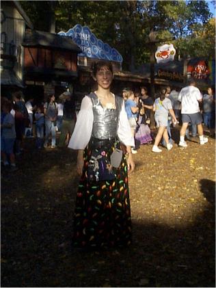 The ever-lovely Kat, on the "Day of Wrong", aka Closing-Day at MD RenaissanceFestival. Many of us dress up in garb that contains at least one thing thatis completely wrong... be it an out of period item, something made withmodern materials, etc. In this case, she wore a bodice made of duct tape,and a skirt with a chili-pepper design. :)