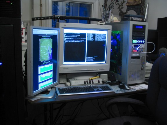 Another closeup of the workstation. The CRT is displaying SSH sessions,and the LCD is showing my<A href="http://www.necrobones.net/weather.shtml">Weather Station</A>.