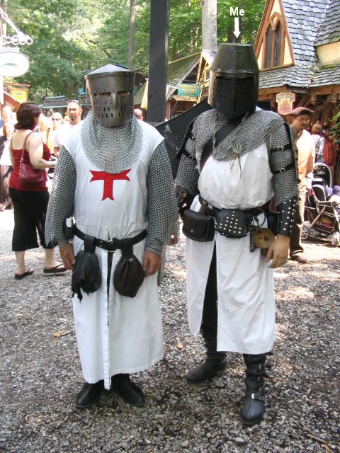 In armor, sporting my new spaulders and shield. I ran intoa fellow Crusader, a Templar who was out and about for theday. We decided to get some pictures. This poor fellow's face was pretty crunched up inside his helmet.Looked as though he pretty well flattened his nose to fit into it.
