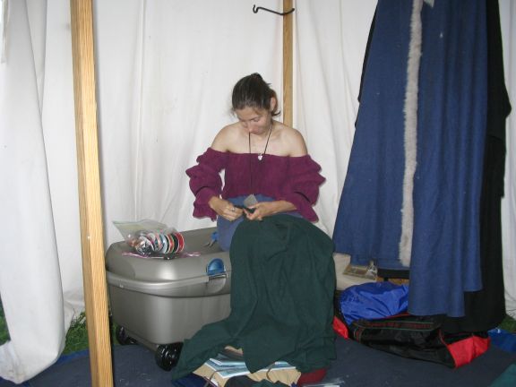 The lovely Lady Ketsia, performing a quick repair on my surcoat. :)