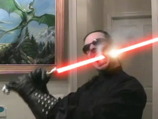 Me, eating a lightsaber. Actually, it's a frame from one of my comedy <A href="//lightsabers.necrobones.com/">lightsaber videos</A>.