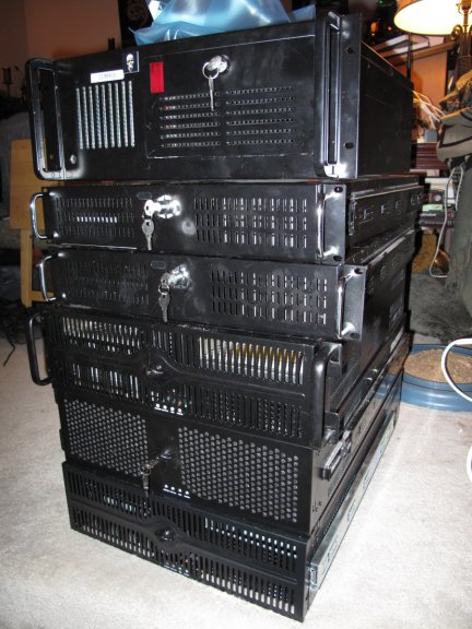 Old rackmount computers stacked up and ready to be donated or trashed.