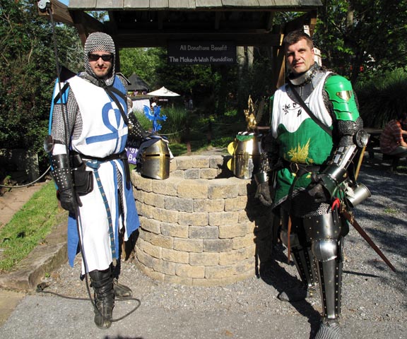 Sir Brian and myself at the wishing well, since it supports ourfavorite charity. Great helms are parked on the well. Too bad youcan't see the mantle, torse, and crest very well.